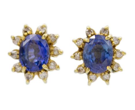 An 18k gold sapphire and diamond cluster stud earrings. The earring size is 9mm x 8.5mm, stamped 18k, total weight 3.46g.
