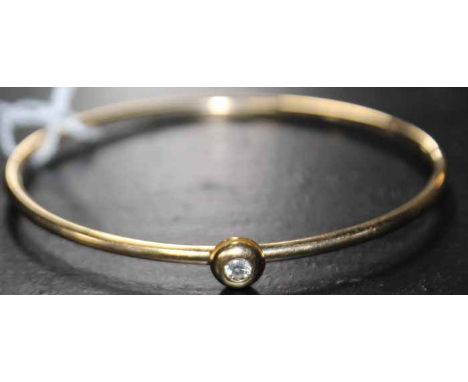 18CT GOLD DIAMOND SET BANGLE
the brilliant cut diamond of approximately 0.15 carats, 7.5g