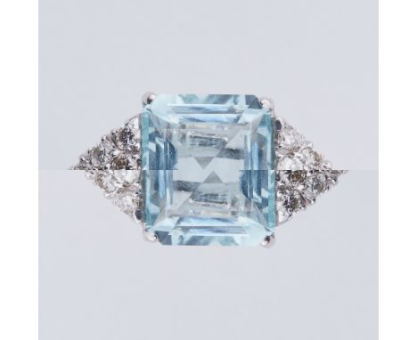 An 18ct white gold ring set with a central emerald cut aquamarine, approx. 4.70 carats, with six diamonds set to each side in
