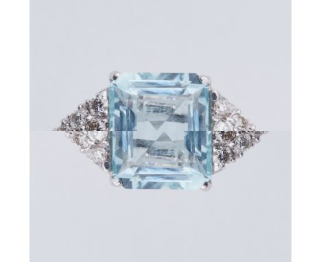 An 18ct white gold ring set with a central emerald cut aquamarine, approx. 4.70 carats, with six diamonds set to each side in