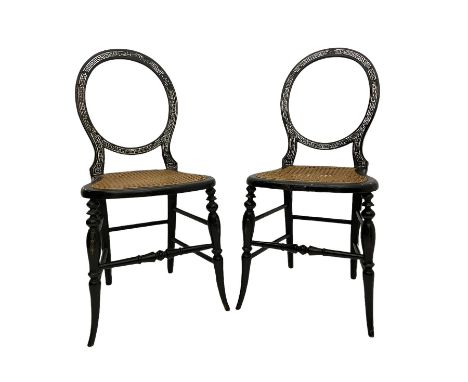 Pair Victorian balloon back bedroom chairs, black lacquered and decorated with mother of pearl in Greek key design, cane seat