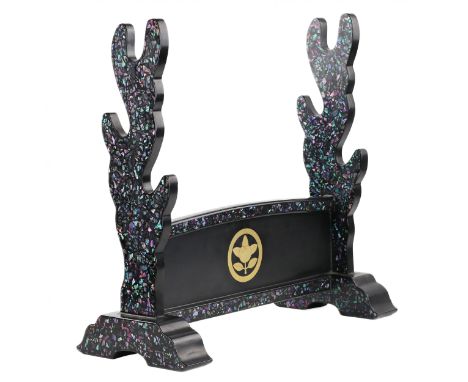 A sword stand (katana`kake) made of black lacquered wood, designed to accommodate three swords. It is decorated with mother-o
