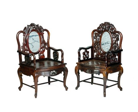 A PAIR OF CARVED HARDWOOD AND MARBLE INSET ARMCHAIRS The back with oval marble inset panel, carved birds and foliage  All ite