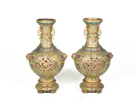 A PAIR OF LARGE CLOISONNE ENAMEL VASES ON STANDS
Late 20th Century, with pierced dragon panel and mask handles

All items sol