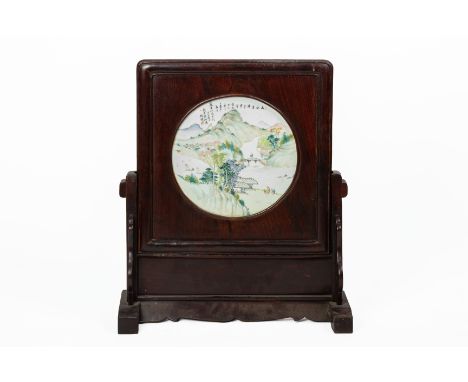 A CHINESE HARDWOOD AND PORCELAIN INSET TABLE SCREEN
Decorated with figures in a mountainous landscape 
Inscribed to the upper