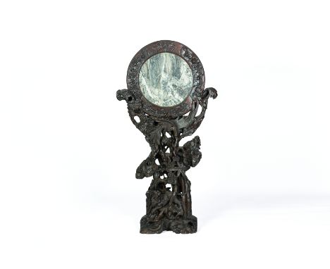 A MARBLE INSET AND CARVED HARDWOOD SCREEN The variegated circular marble panel within a foliate carved, surround, supported o