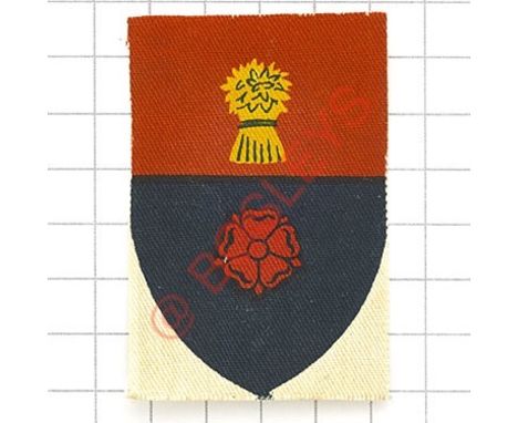 Badge. 92nd Army Group Royal Artillery (AGRA) printed formation sign. Red over blue shield, top section wit Cheshire garb, lo
