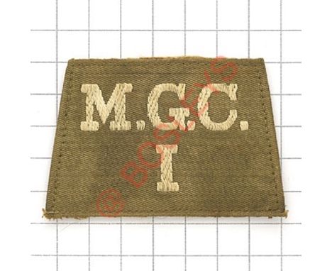 Badge. M.G.C. / I rare WW1 Machine Gun Corps Infantry slip-on shoulder title. White embroidered on light khaki, buckram backi