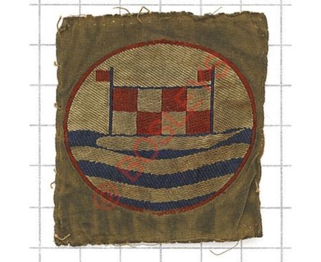 Badge. Coast Artillery Training School scarce formation sign. Silk circle bearing flagged target with waves below, embroidere