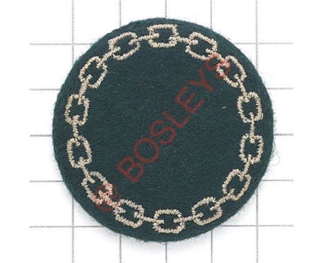 Non military personnel scarce WW2 cap badge. Green padded cloth disc embroidered with chain border. Worn by civilians such as