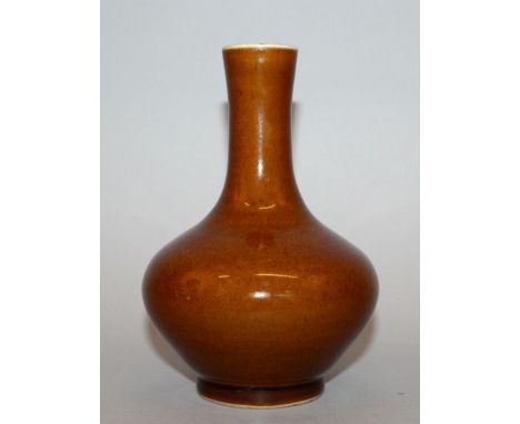 A CHINESE PORCELAIN BOTTLE VASE, applied with a cafe-au-lait type glaze, the base with a six-character Wanli mark, 6.25in hig