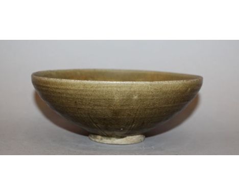 ANOTHER CHINESE SONG DYNASTY PORCELAIN BOWL, possibly Yaozhou, the interior with simple carved decoration beneath a brownish 