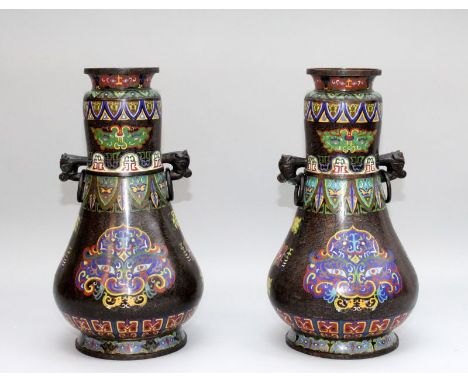 A VERY LARGE PAIR OF CHINESE CLOISONNE VASES, each pear shaped body decorated with large archaic taotie masks against a key-f