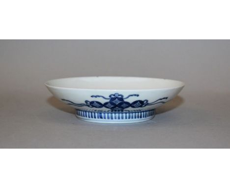 A 19TH CENTURY JAPANESE NABESHIMA BLUE & WHITE PORCELAIN DISH, with a comb foot, the interior painted with a bird perched on 