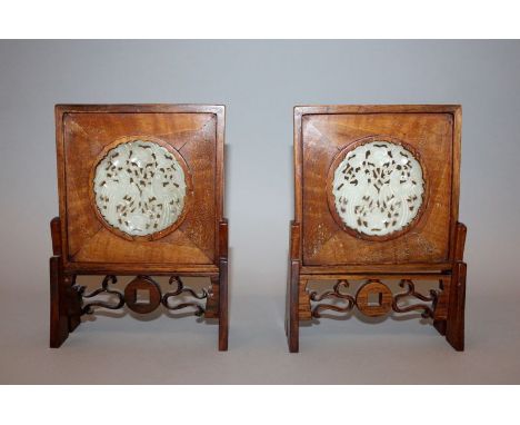 A PAIR OF EARLY 20TH CENTURY CHINESE WOOD & JADE TABLE SCREENS, each screen centred by a pierced and carved circular jade pla