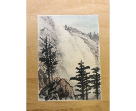 A 20TH CENTURY CHINESE SCROLL PAINTING ON PAPER, depicting a mountainous landscape, on a patterned silk mount, the painting i