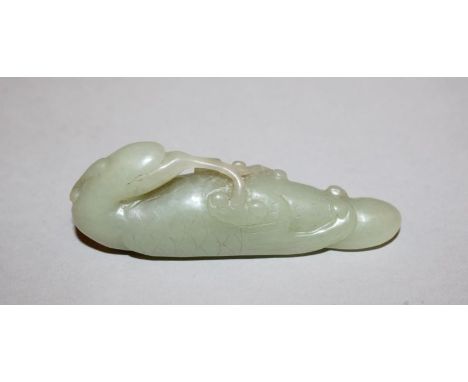 A CHINESE CELADON GREEN JADE CARVING OF A PHOENIX, the head turned backwards and with a spray of lingzhi in its beak, 3.6in l