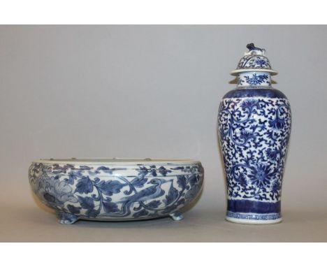 A CHINESE BLUE & WHITE BOMBE PORCELAIN BOWL, supported on three paw bracket feet, the sides decorated with bids and scrolling