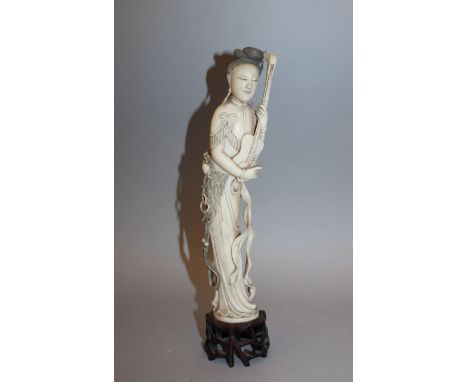 A GOOD QUALITY 19TH CENTURY CHINESE IVORY FIGURE OF A LADY, together with a fitted wood stand, the ivory weighing 590gm, the 