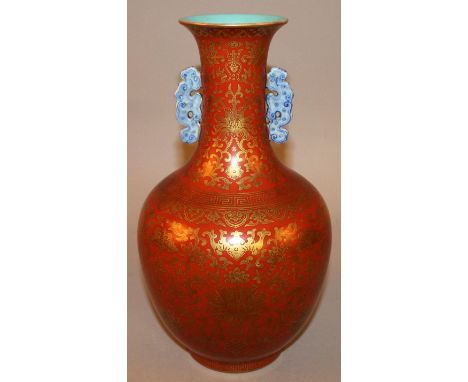 A GOOD QUALITY CHINESE GILT DECORATED IRON-RED PORCELAIN VASE, the base with a Qianlong seal mark, the sides decorated overal