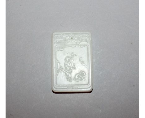 A CHINESE WHITE JADE-LIKE PENDANT, of rectangular form, decorated with a panel of calligraphy and of a boy, 2in x 1.3in.