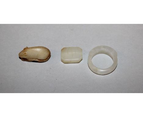 A CHINESE JADE-LIKE RING, together with two other small jade-like pieces. (3)