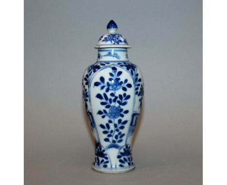 A CHINESE KANGXI PERIOD BLUE & WHITE PORCELAIN VASE & COVER, circa 1700, the sides of the baluster form body painted with pan