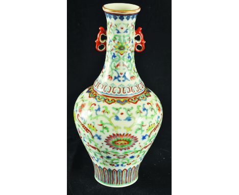 A CHINESE DOUCAI PORCELAIN VASE, the sides and neck decorated with formal scroll-stemmed foliage, the base with a Qianlong se