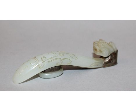 AN 18TH/19TH CENTURY CHINESE CELADON JADE BELT HOOK, with a silver fitting engraved with prunus and impressed with an ‘HK’ ma