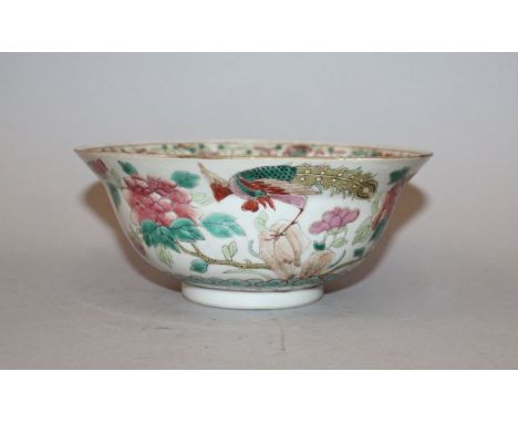 A LATE 19TH CENTURY CHINESE FAMILLE ROSE PORCELAIN BOWL, the sides painted with two scenes of a peacock, rockwork and peony, 