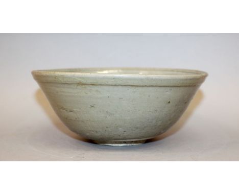 A GOOD CHINESE SONG DYNASTY CELADON PORCELAIN BOWL, the interior incised with stylised flowerheads, 7.5in diameter & 3.1in hi