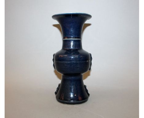 A CHINESE BLUE GLAZED PORCELAIN VASE, of near Gu form, with underglaze decoration of dragons and phoenix, the base with a six