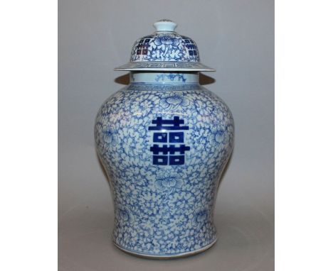 A CHINESE BLUE & WHITE PORCELAIN JAR & COVER, decorated with Shou symbols on a ground of scrolling foliage, the base with a f