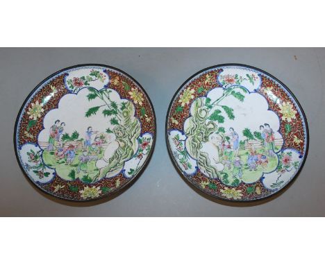 A MIRROR PAIR OF 19TH/20TH CENTURY CHINESE CANTON ENAMEL DISHES, each unusually decorated with ladies and children visiting B