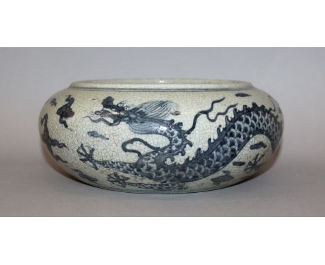 A CHINESE BLUE & WHITE PORCELAIN DRAGON BOWL, of bombe form, the base unglazed, 10.75in wide at widest point.