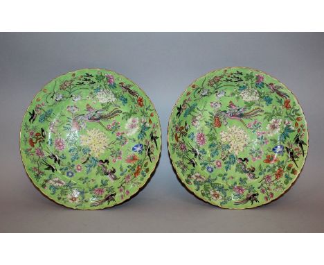 A FINE PAIR OF CHINESE DAOGUANG MARK & PERIOD LIME-GREEN GROUND FAMILLE ROSE PORCELAIN DISHES, each interior well painted in 