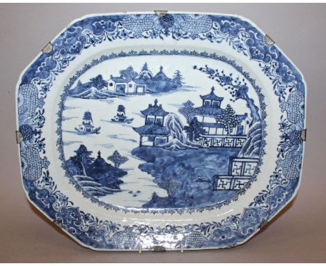 A LARGE 18TH CENTURY CHINESE QIANLONG PERIOD BLUE & WHITE PORCELAIN EXPORT DISH, painted with a river landscape setting, the 