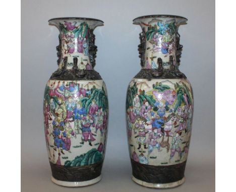 A LARGE NEAR PAIR OF CHINESE FAMILLE ROSE CRACKLEGLAZE PORCELAIN VASES, circa 1900, each painted with scenes of warriors, 23.