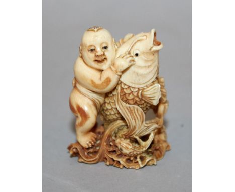 A GOOD QUALITY 19TH/20TH CENTURY SIGNED JAPANESE IVORY NETSUKE OF KINTARO RIDING THE CARP, the two supported on pierced waves