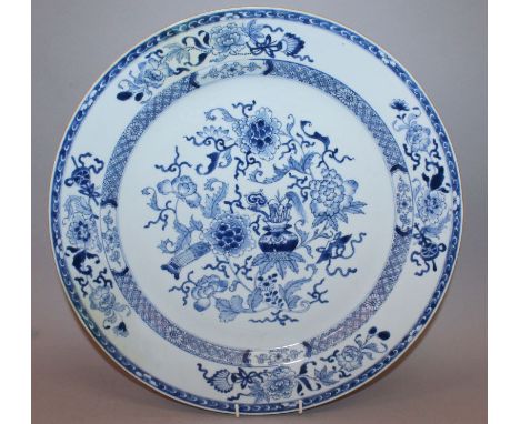 A LARGE EARLY 18TH CENTURY CHINESE BLUE & WHITE PORCELAIN CHARGER, painted with peony and precious objects, 16.1in diameter.