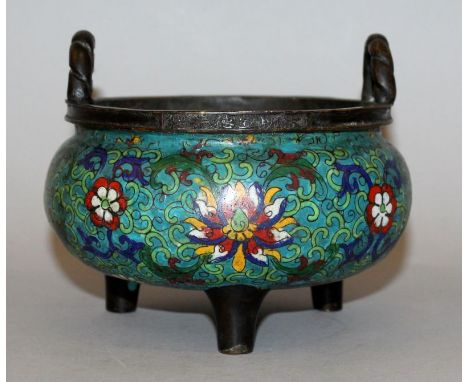 A CHINESE CLOISONNE TRIPOD CENSER, the sides decorated with scroll-stemmed lotus, the rim with a six-character Xuande mark, 5