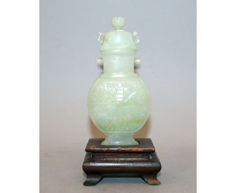 AN EARLY 20TH CENTURY CHINESE CELADON JADE-LIKE VASE & COVER, together with a fitted wood stand, the rounded rectangular-sect