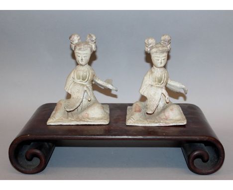 A PAIR OF CHINESE TANG STYLE POTTERY FIGURES OF FEMALE MUSICIANS, possibly early, each with traces of pigment, each 7.1in hig