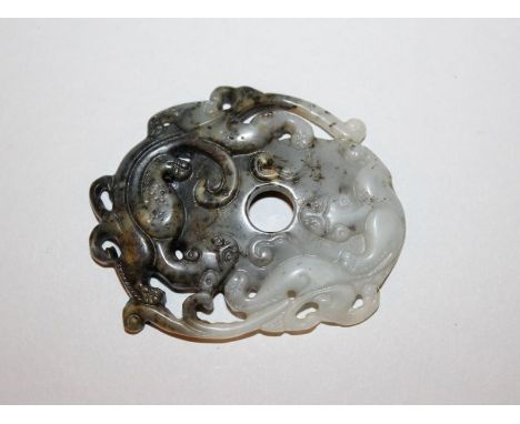 A CHINESE JADE-LIKE GROUP OF TWO CONFRONTING CHILONG, the stone of predominantly grey tone with darker inclusions, 2.8in x 2.