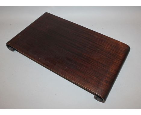 A 19TH/20TH CENTURY CHINESE SCROLL-END HARDWOOD STAND, of shallow form, 17.1in x 9.75in.