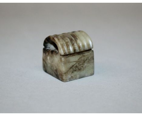 AN UNUSUAL BROWN JADE SEAL, of square-section with a grooved semi-circular top, 0.9in square & 1.1in high.