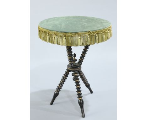 A VICTORIAN PARCEL GILT EBONISED GYPSY TABLE, the upholstered circular top raised on three bobbin turned supports issuing fro