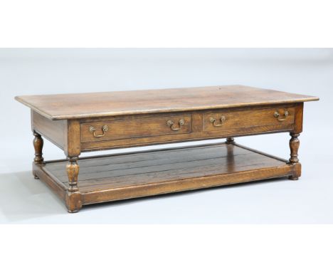 A LARGE PERIOD STYLE OAK COFFEE TABLE IN THE MANNER OF TITCHMARSH AND GOODWIN,&nbsp;the moulded rectangular top over a pair o