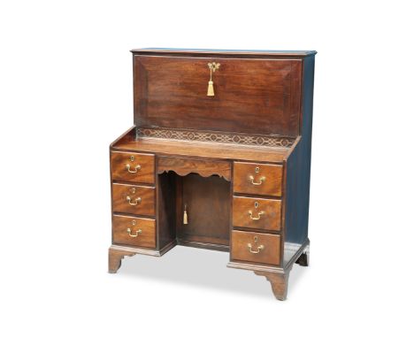 A GEORGE III MAHOGANY FALL-FRONT DESK, the moulded rectangular top above a fall-front with solid brass escutcheon, opening to