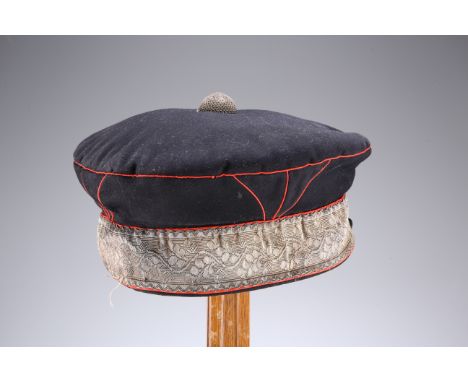 A VERY RARE MID 19TH CENTURY OFFICERS' PATTERN BRODERICK CAP, in navy blue with fine red piping , silver lace and top button,